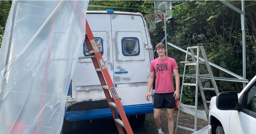Cole Vander Wall standing by a van build in progress